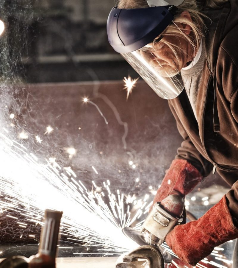 factory-worker-grinding-a-steel-edge-in-a-sheet-metal-factory--e1614160331702
